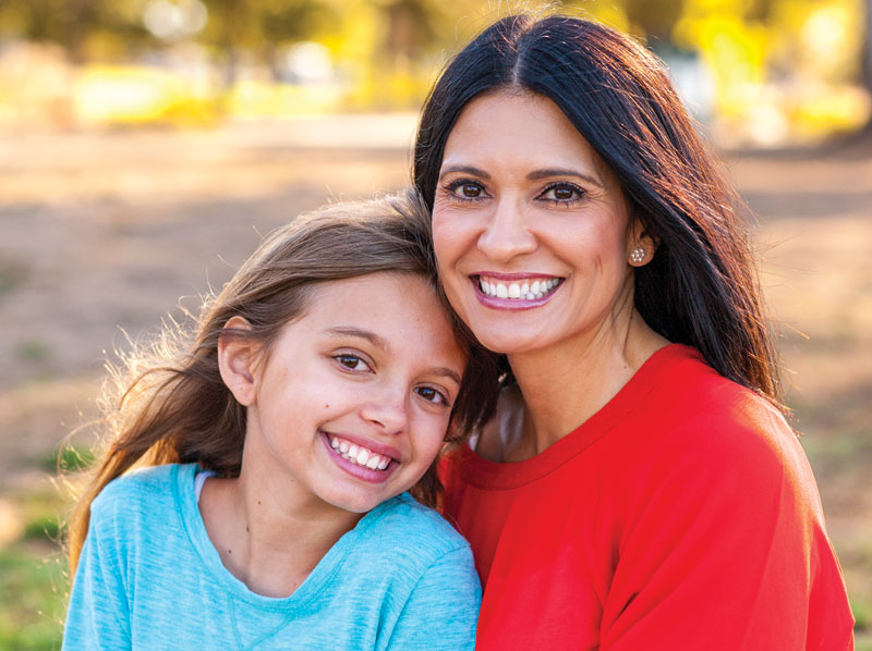 Mother and daughter smiling.